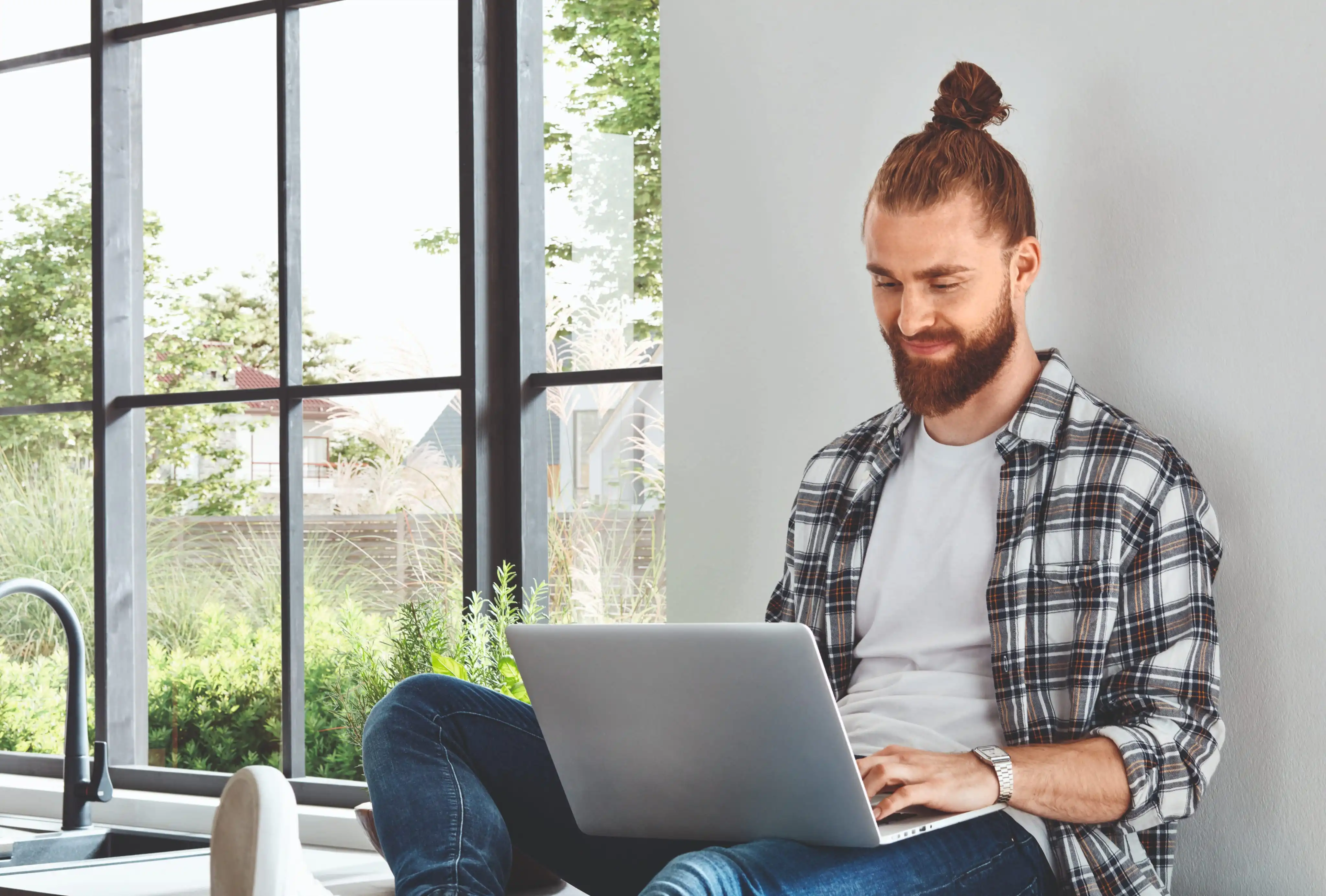 Man on laptop in kitchen